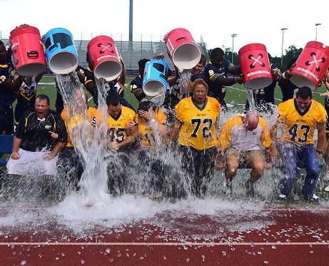 MGCCC head football coach Chad Huff (6th from left) and the MGCCC Ex. Council members get doused by football players & cheerleaders in the ALS Ice Bucket Challenge Aug. 21.
