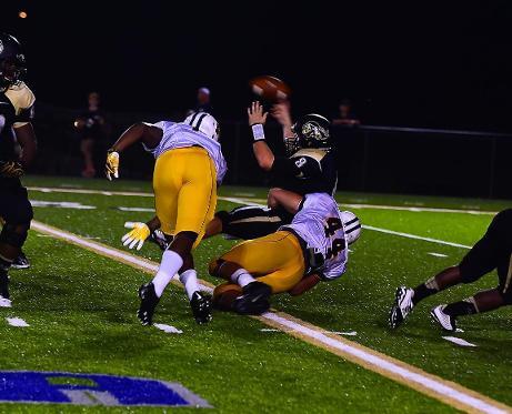 MGCCC'S Barron Miller (#44) pulls down East Central QB Ethan Hamilton and forces an intercepted pass. Tony Bridges picked off the throw for a 32-yard TD.