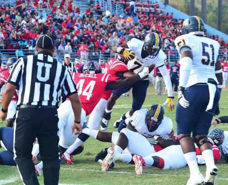 Martinas Rankin looks on as MGCCC QB Jason Smith (#7) leaps into the end zone for a TD Oct. 25.